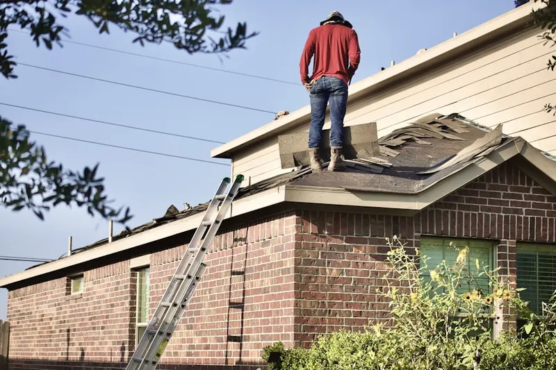 Professional roofer working on a residential roof in Meadow Point